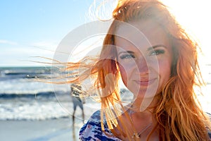 Young woman with long red hairs