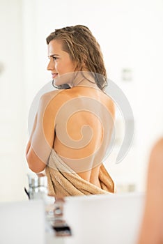 Young woman with long wet hair in bathroom