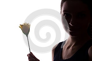 Young woman look ahead with flower - horizontal silhouette of a side view