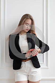 Young woman look at clock at time, be late and rush. Vertical shot planning concept