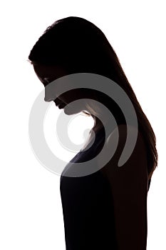 Young woman look down with flowing hair - vertical silhouette