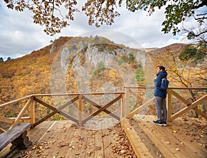 Young woman looking on autumn canyon