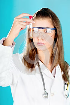 Young woman looking at the chemical tube