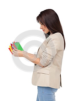 Young woman looking at colorful papers