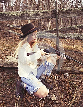 Young woman looking down the barrel of a gun