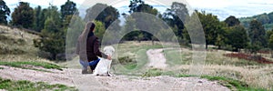 Young woman looking in horizon with puppy