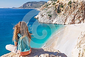 Young woman looking at Kaputas beach, Lycia coast, Turkey photo