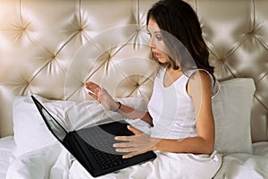 Young woman looking in laptop`s screen