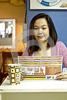 Young woman looking menu