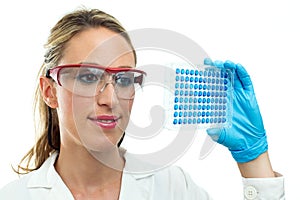 Young woman looking a microplate