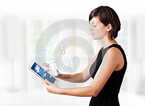 Young woman looking at modern tablet with social icons