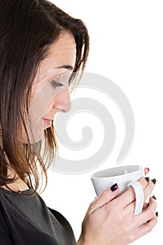 Young woman looking mug coffee tea cup in closeup portrait on white background