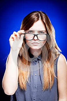 Young woman looking through the nerd glasses