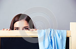 Young woman looking out from the locker room