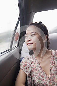 Young Woman Looking Out Window In Taxi