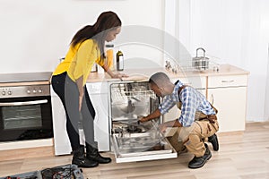 Repairing Dishwasher In Kitchen