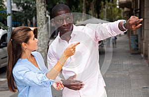 Woman asking man to show way