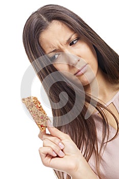 Young woman looking sad for a cereal bar