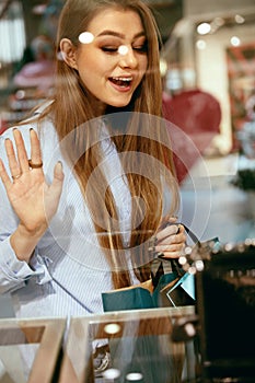 Young Woman Looking Through Shop Window