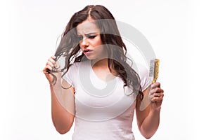 Young woman looking at split ends.