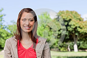 Young woman looking straight ahead with a smile on her face