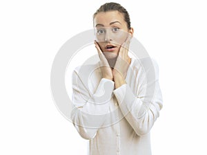 Young woman looking surprised against white background