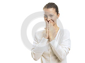 Young woman looking surprised against white background