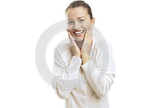 Young woman looking surprised against white background