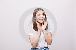 Young woman looking surprised on white background