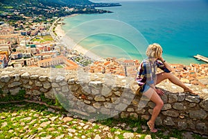 Young woman looking to the Cefalu, Sicily