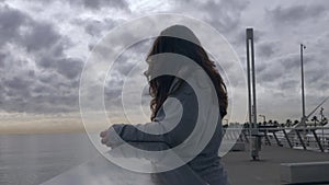 Young woman looks at beautiful landscape from a viewpoint