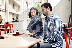 Young woman looks displeased at the guy.