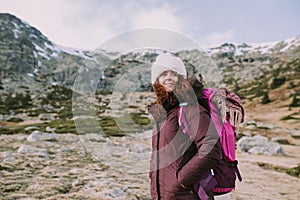 Young woman looks far while enjoying the mountain
