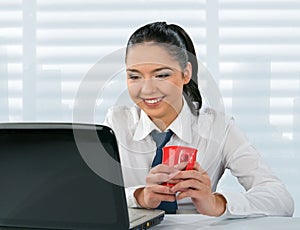 Young woman looks at her laptop computer
