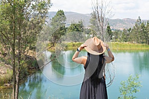 Woman looks out across mountain lake photo