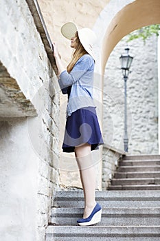 Young woman looks over the rocky fence