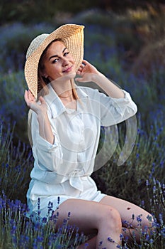 Young Woman Looks Tenderly at the Camera Among Lavender. Girl Working Lavender Plantation