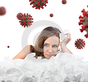 Young woman with a lot of hankys among coronavirus cells.