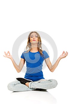 Young woman in lotus yoga pose.