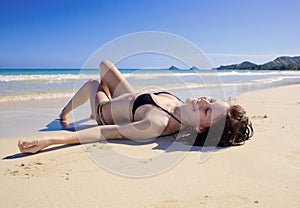 Young woman lounging at the beach