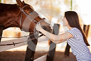 Young woman loving her horse