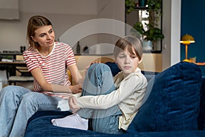 Young woman loving mother trying to talk to upset depressed teenage son. Adolescence