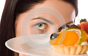 Young woman with low-calorie fruit cake photo