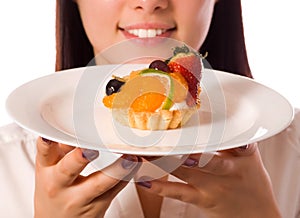 Young woman with low-calorie fruit cake