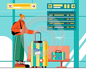 young woman with luggage waiting flight at standing in front of big glass window looking at the flight information screen.