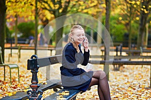 Young woman in the Luxembourg garden of Paris on a fall day