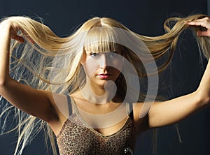 Young woman with luxurious long blond hair