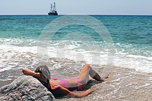 Young woman lying on the beach