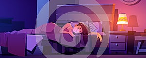 Young woman lying in bed with cellphone in hands