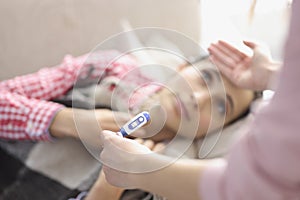 Young woman lying on bed had fever and chills closeup photo